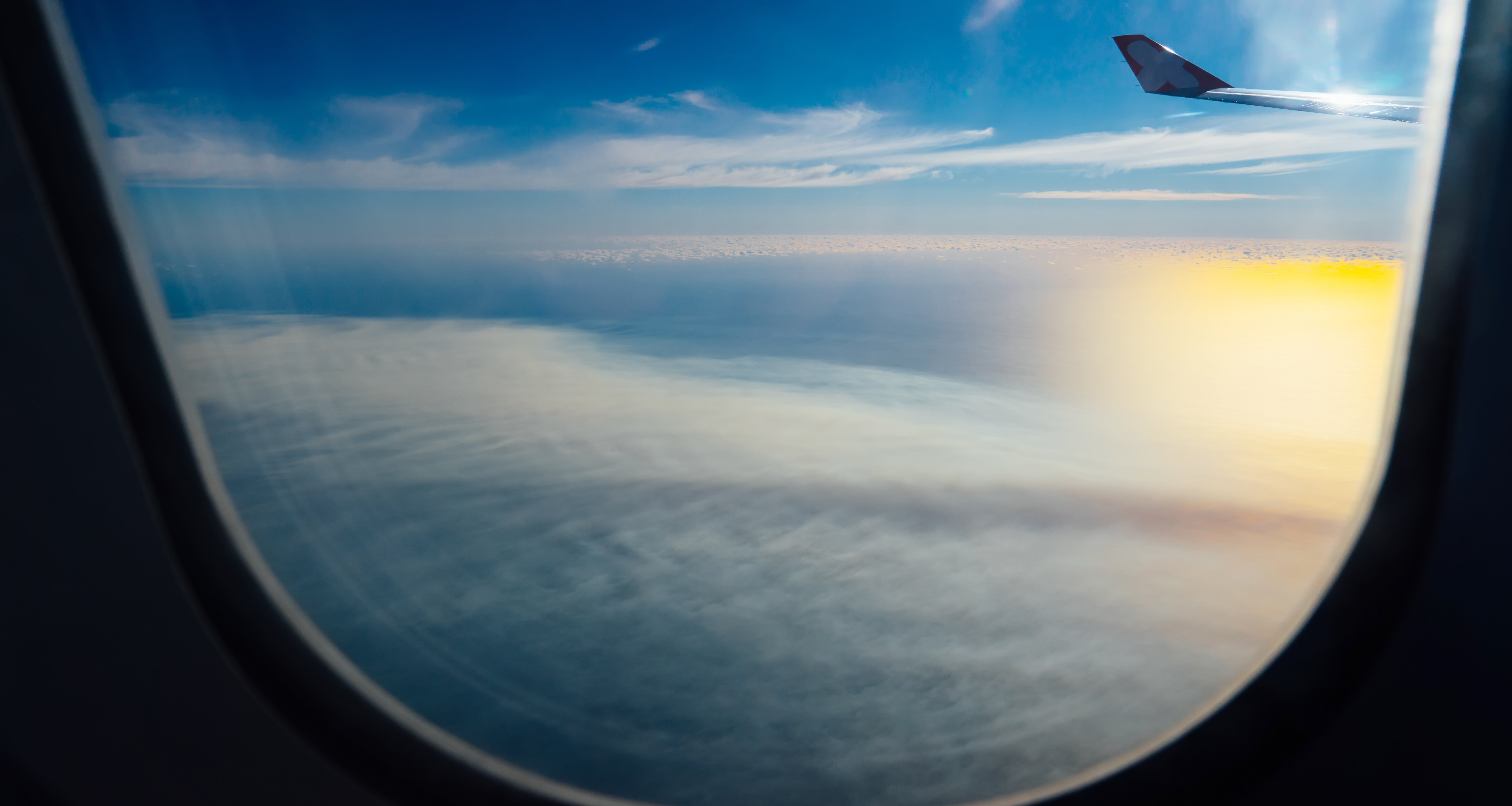 clouds-and-sky-as-seen-through-window-of-an-aircraft-SBI-301985939